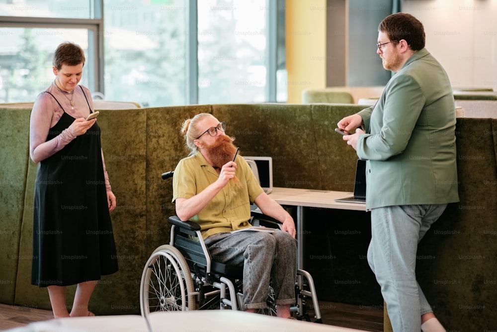 a man in a wheelchair talking to a woman