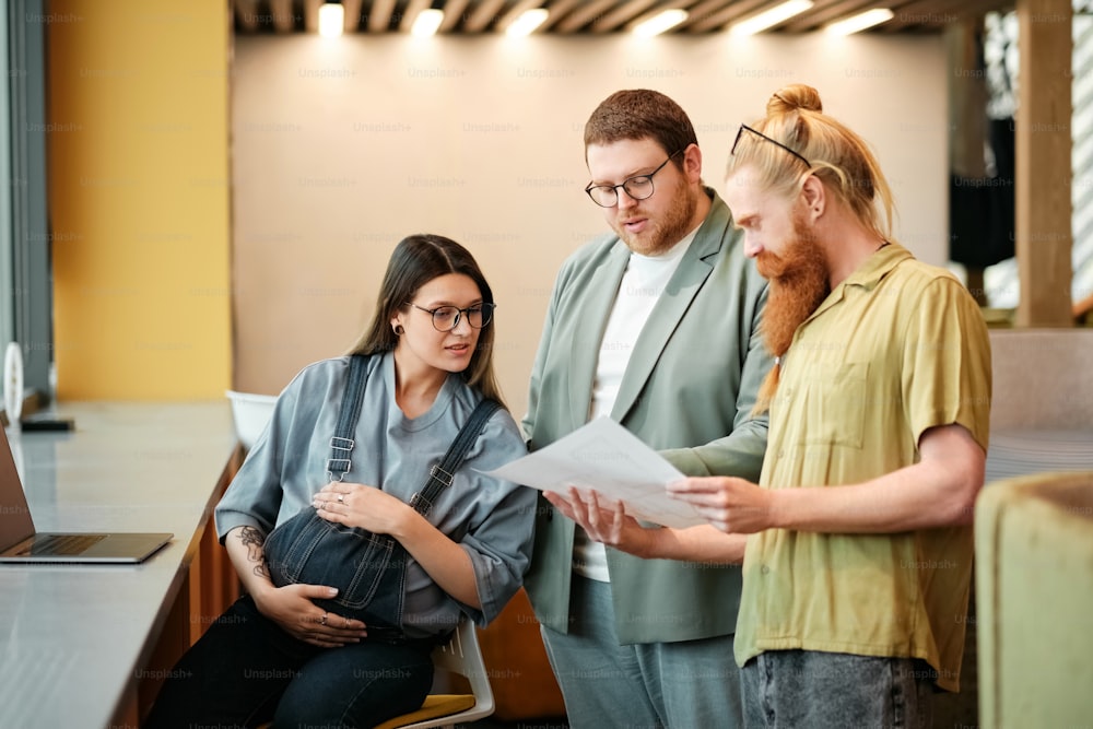 a group of people standing around each other in a room