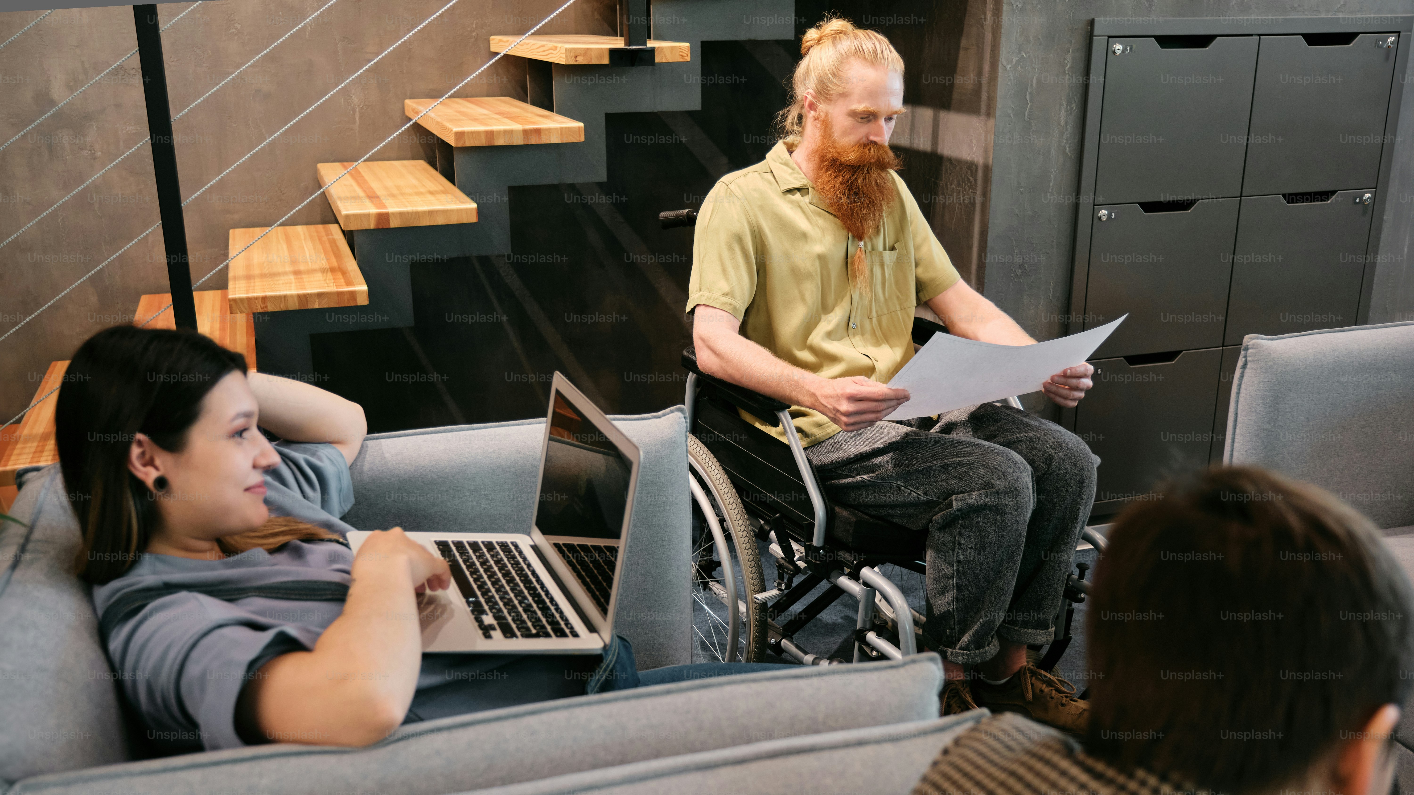 A woman sitting in a wheel chair next to a man in a wheelchair photo ...