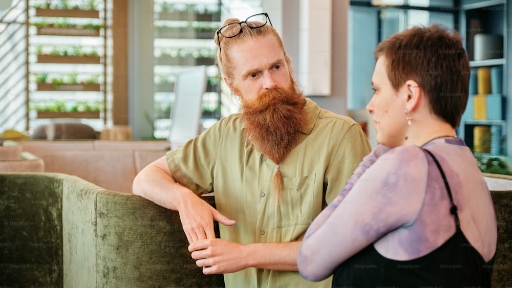 a man with a red beard standing next to a woman