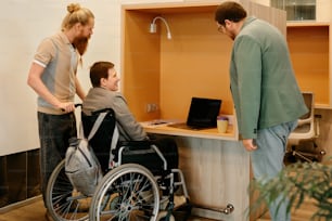 a man in a wheel chair talking to a woman in a wheelchair