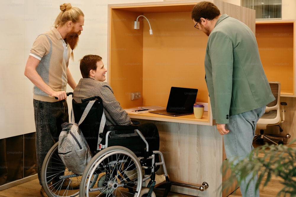 a man in a wheel chair talking to a woman in a wheelchair