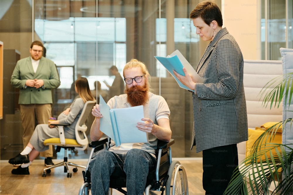 a man in a wheel chair reading a book