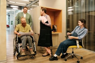 a group of people standing and sitting around a room