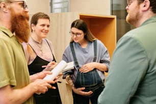 a group of people standing around each other