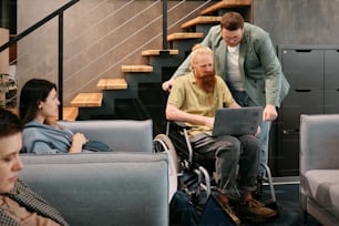 a man in a wheel chair working on a laptop