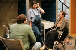 a man in a wheel chair talking to a woman