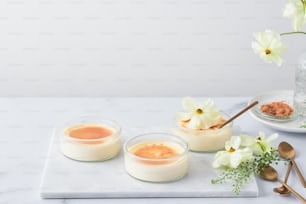 a table topped with bowls of food and a vase of flowers