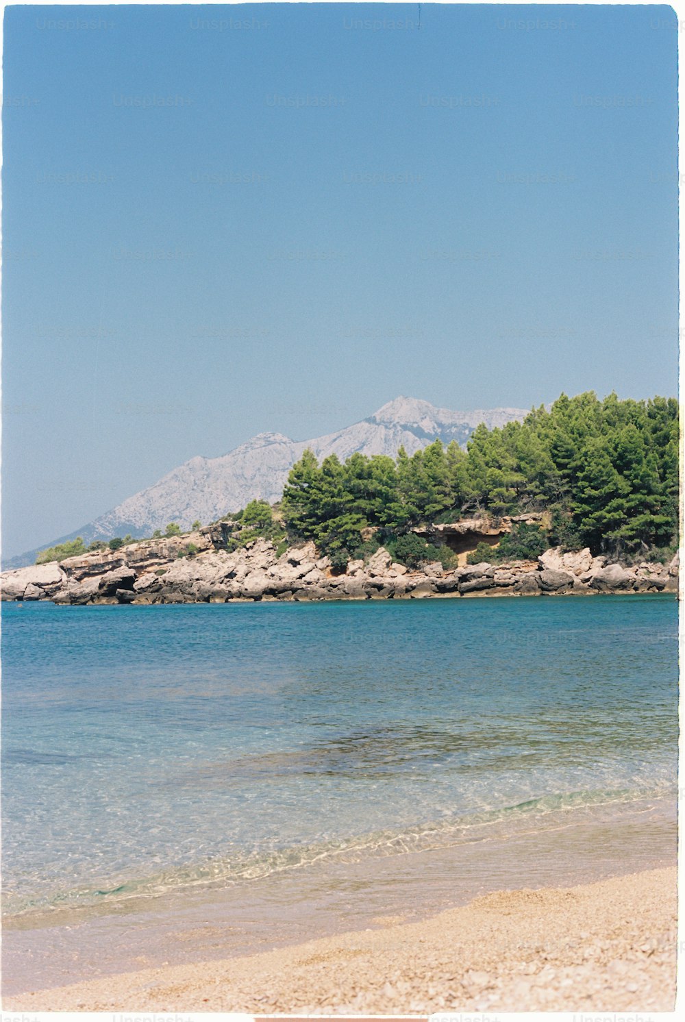 a beach with a mountain in the background