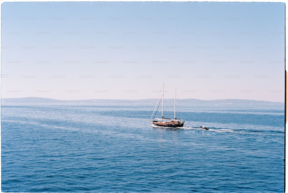 a sailboat sailing across a large body of water