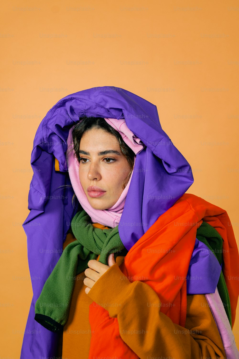 a woman wearing a purple, orange, and green scarf