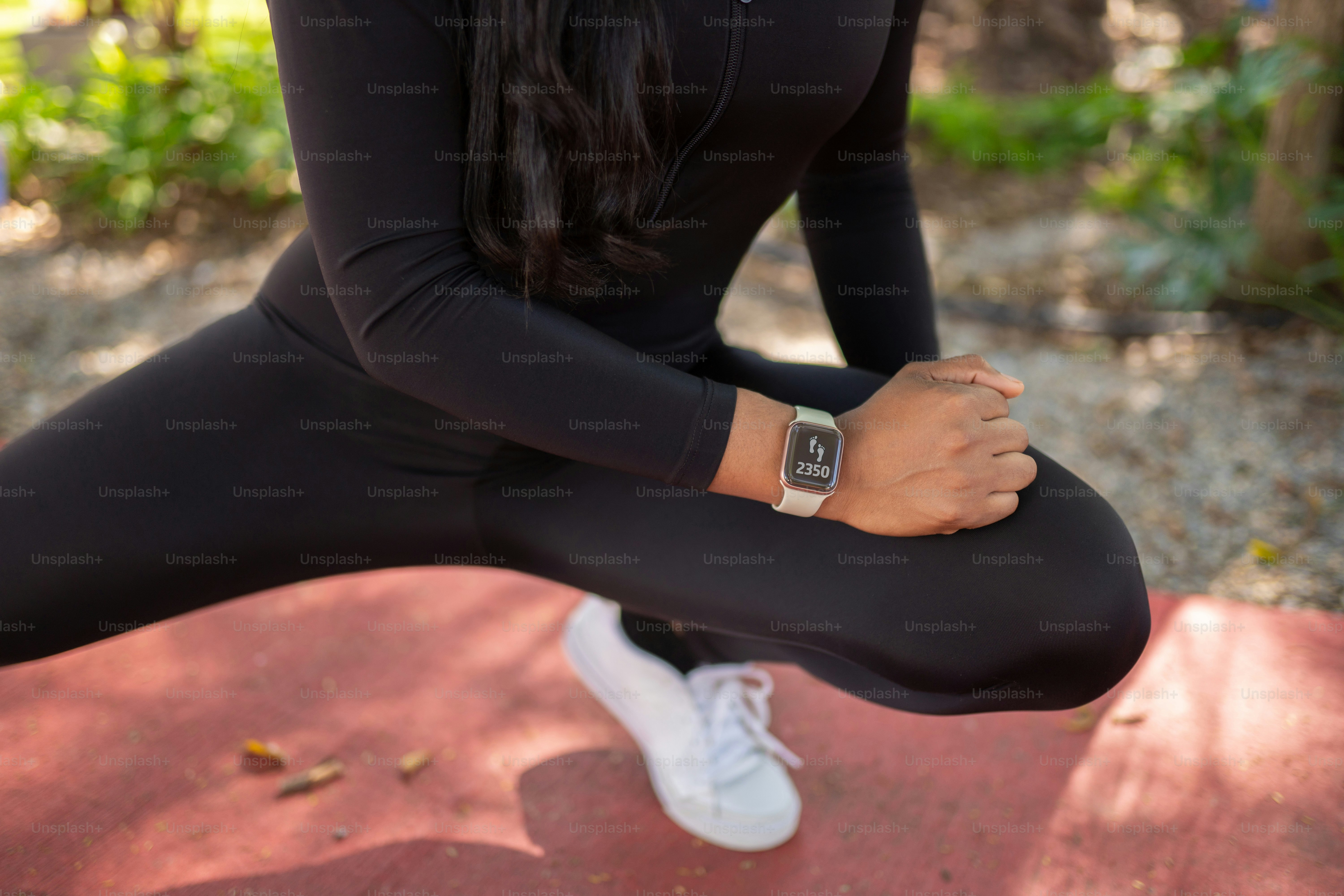 a woman in a black top and black leggings