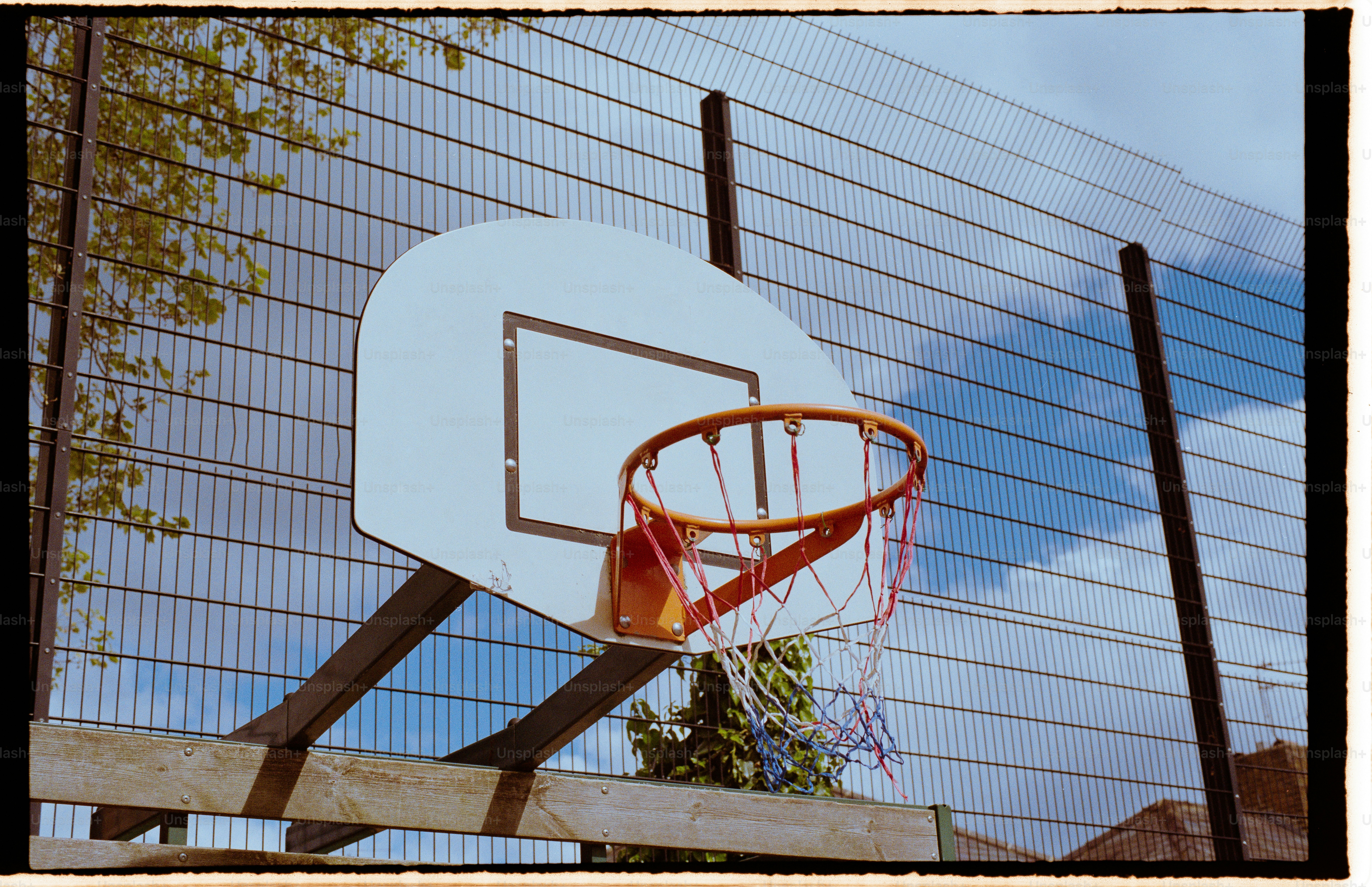 a basketball hoop in front of a fence