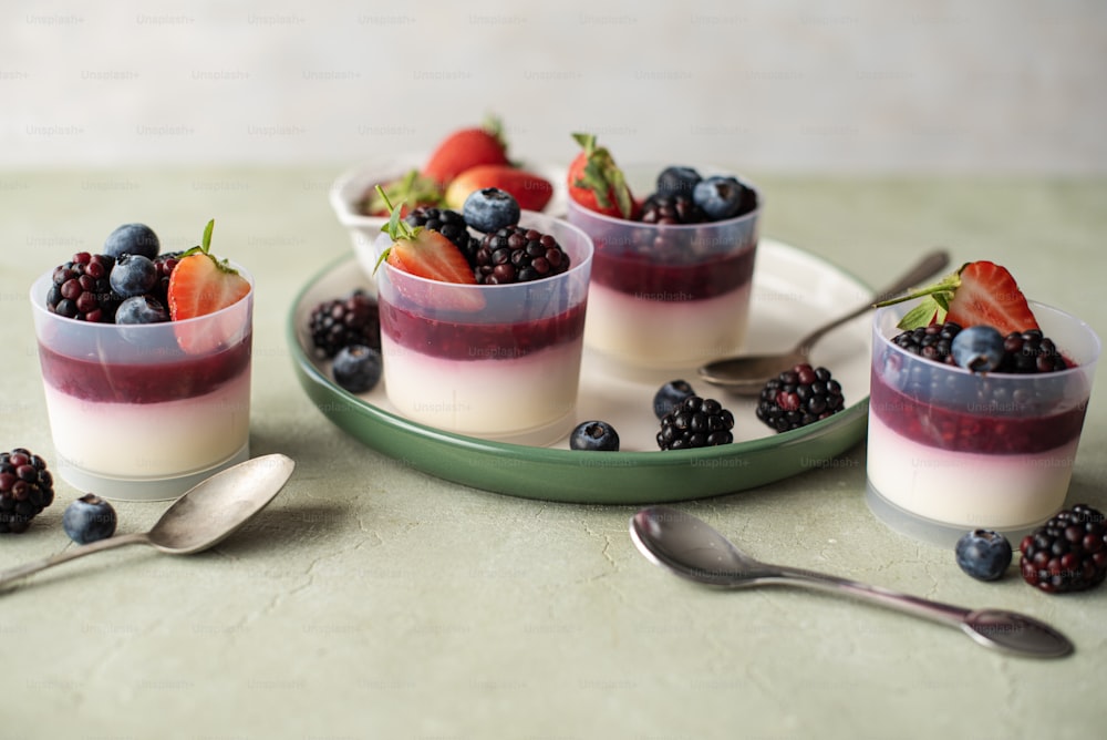 three desserts with berries and yogurt on a plate
