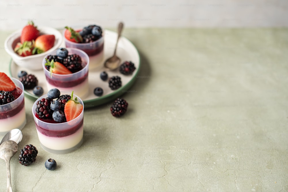 a couple of cups filled with fruit on top of a table