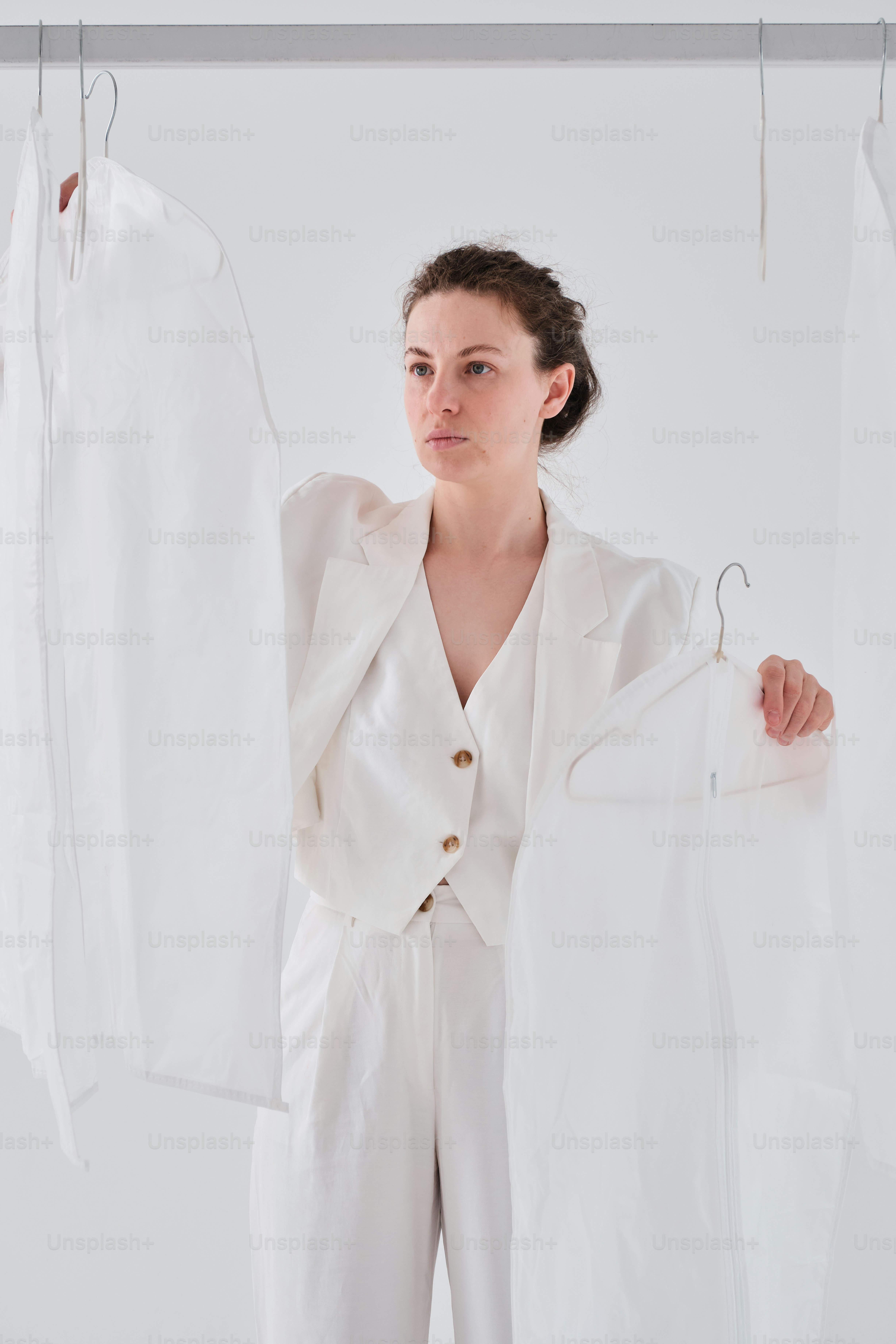a woman standing in front of a rack of clothes