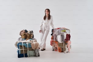 a woman standing next to a rack of clothes