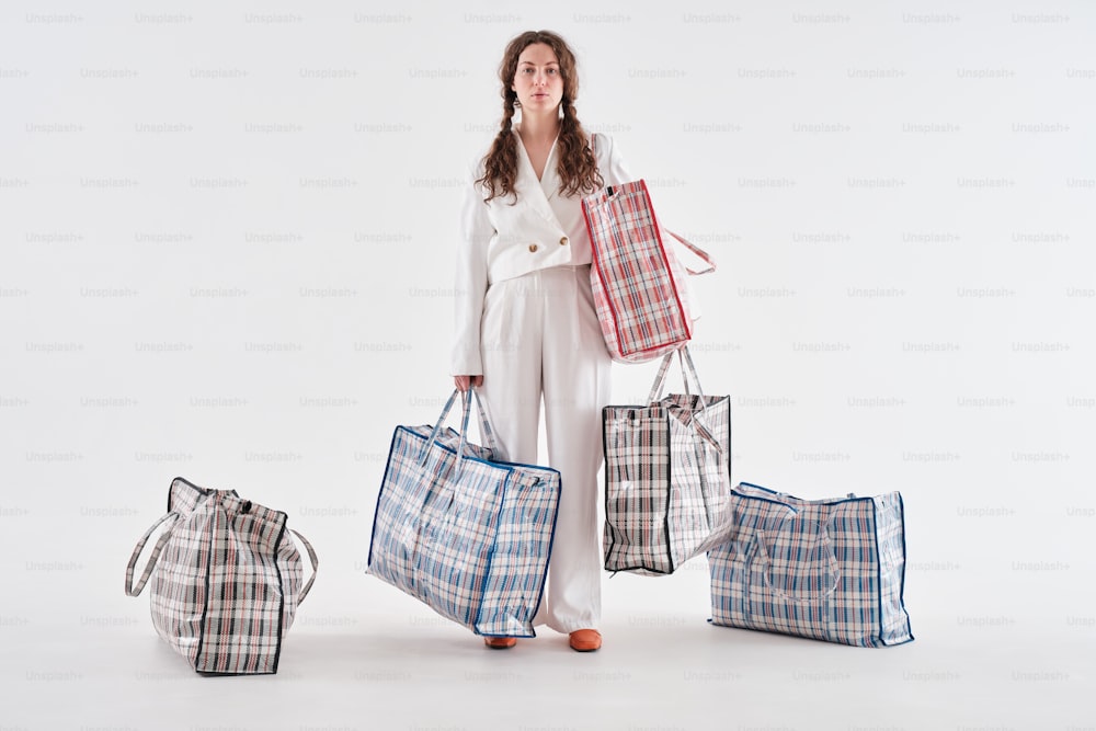 a woman standing in front of four bags
