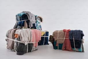 a pile of clothes sitting on top of a metal rack