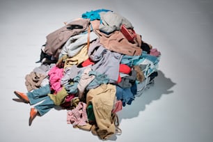 a pile of clothes sitting on top of a white table