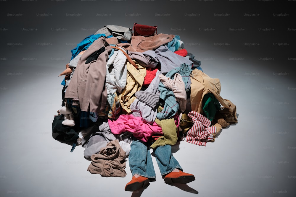 a pile of clothes sitting on top of a white floor