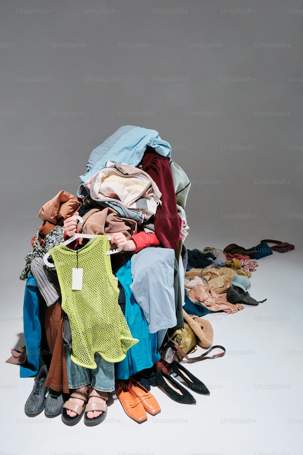 a pile of clothes sitting on top of a white floor