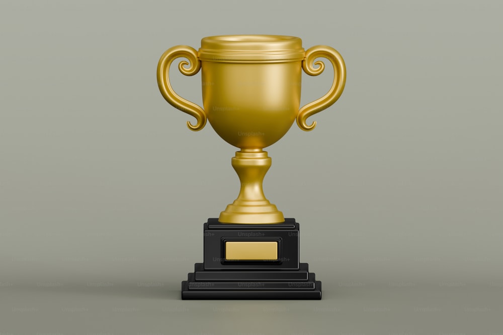 a golden trophy cup sitting on top of a black pedestal