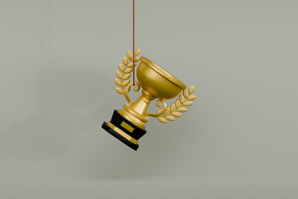 a gold trophy hanging from a rope