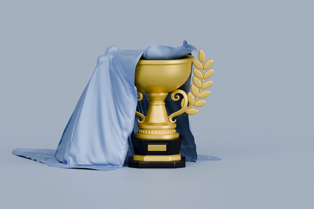 a golden trophy with a blue cloth draped around it