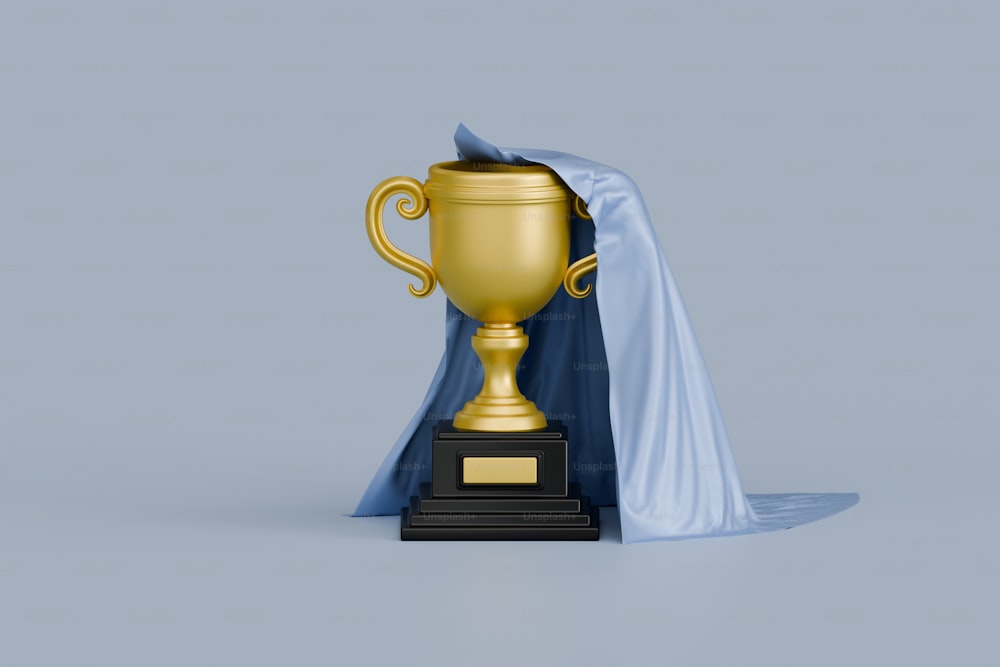 a golden trophy with a blue cape around it
