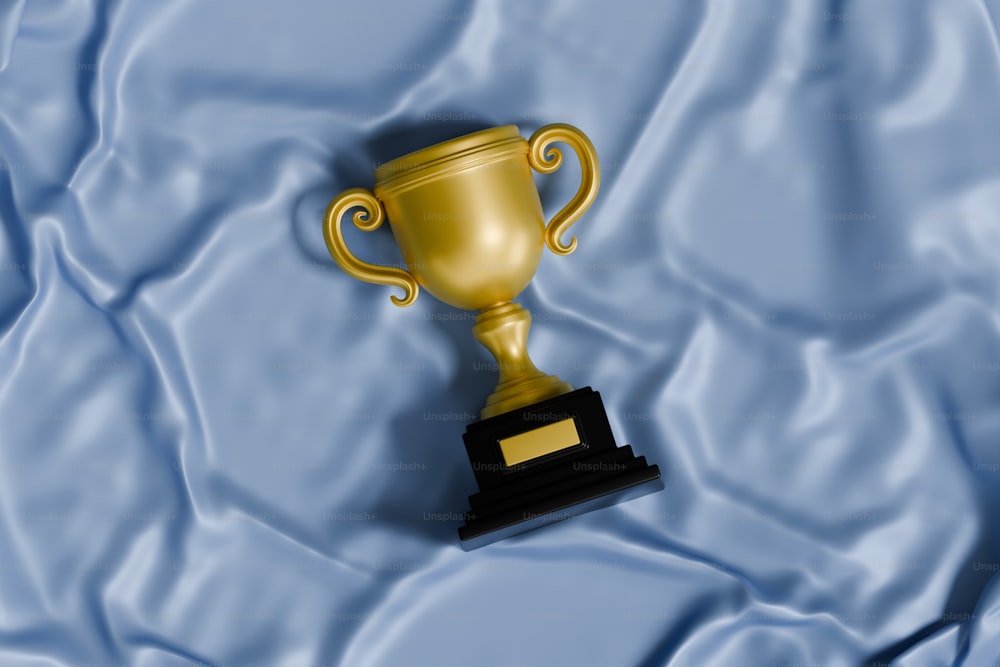 a golden trophy sitting on top of a blue blanket