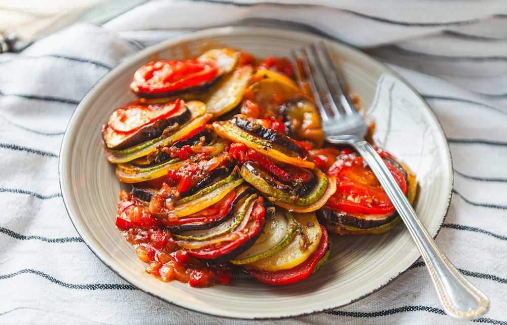 a white plate topped with sliced up vegetables