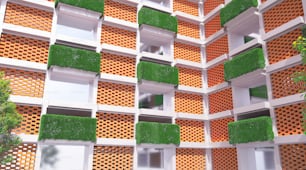 una pared de ladrillos naranjas y blancos con hierba creciendo en ellos