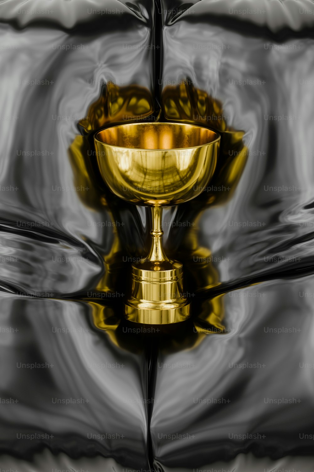 a golden cup sitting on top of a bed