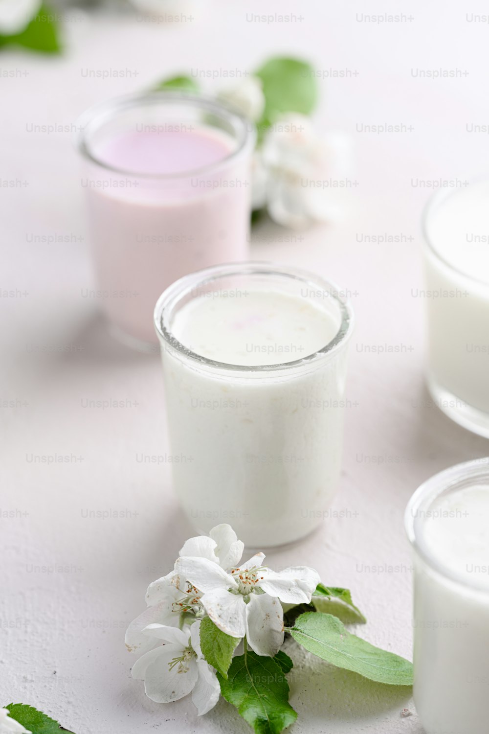 a table topped with three glasses of milk