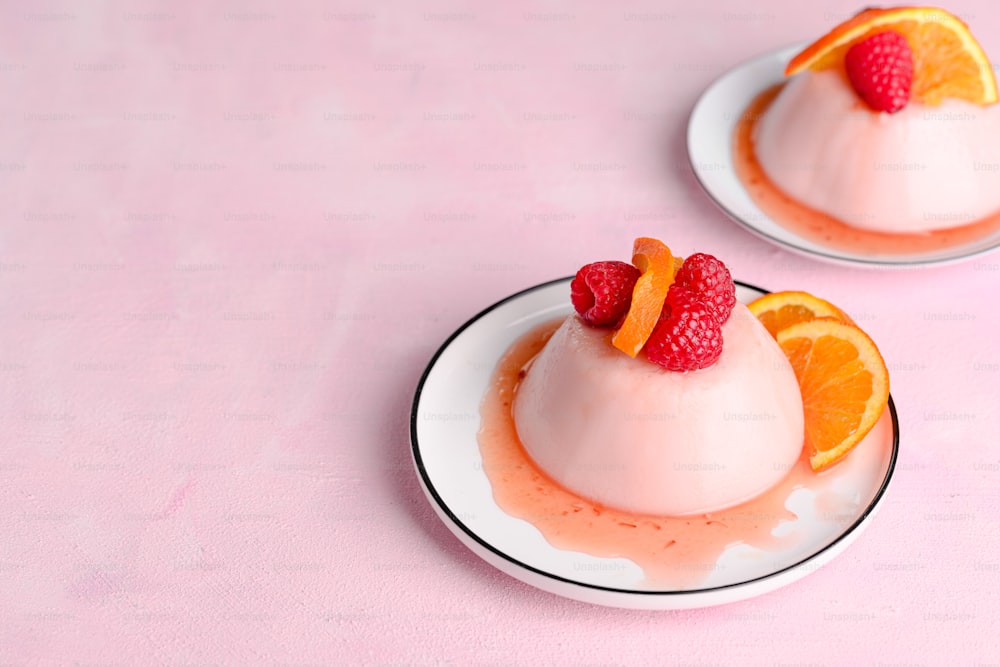 two small desserts with fruit on top of them