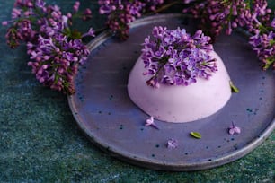 a plate that has some purple flowers on it