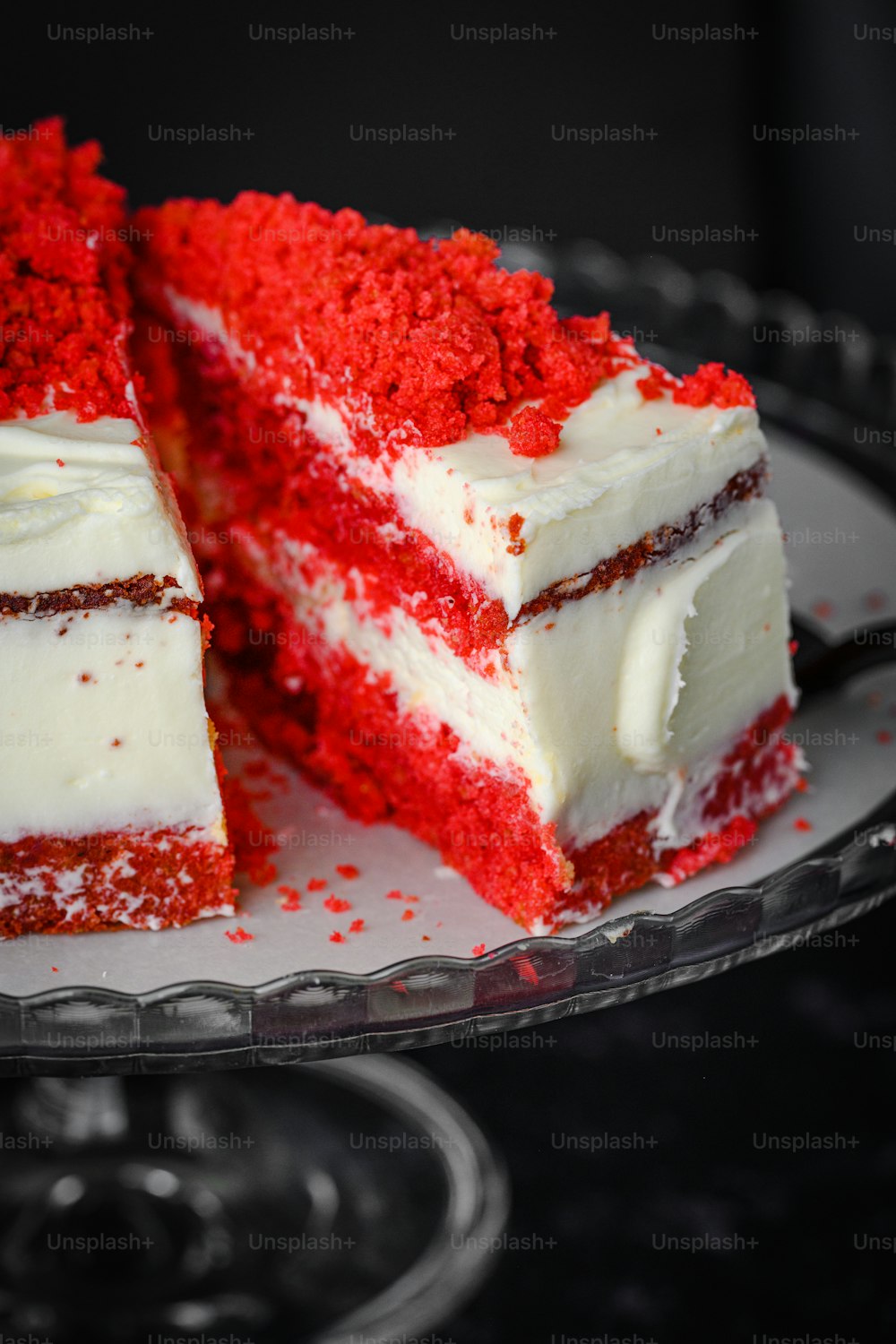 a slice of red velvet cake with white frosting