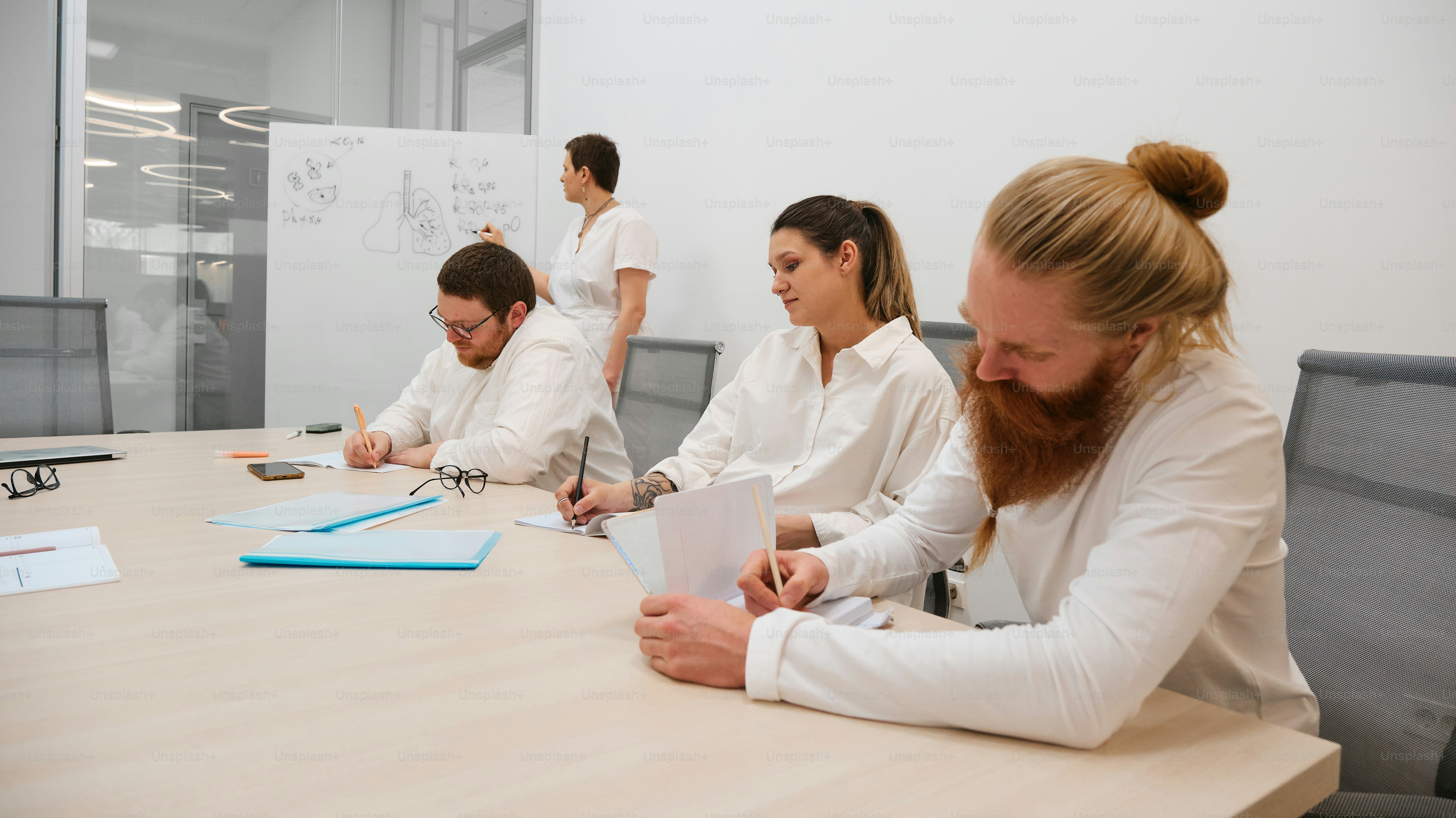 a group of people sitting around a conference table