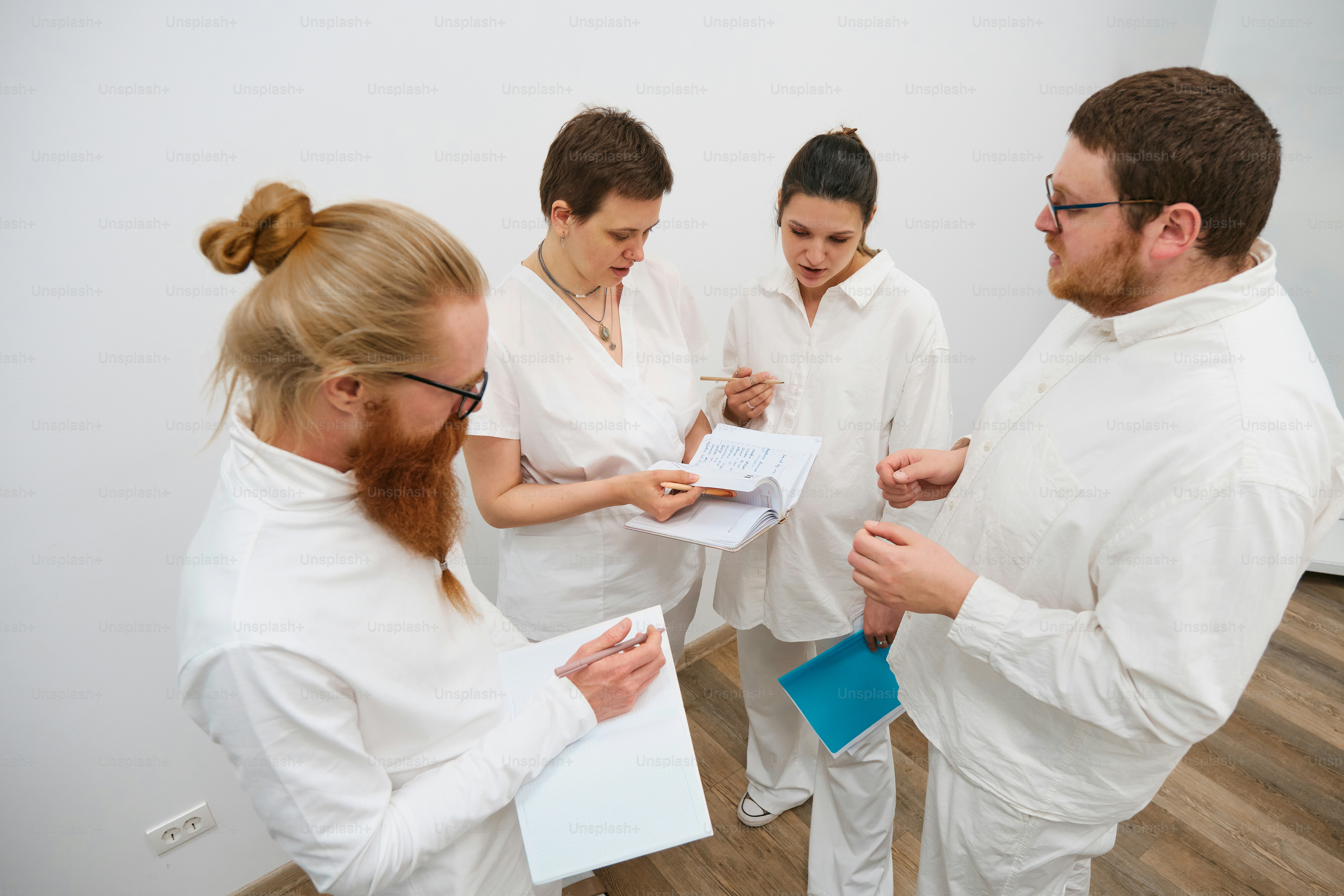 A group of people standing around a white board photo – Education Image ...