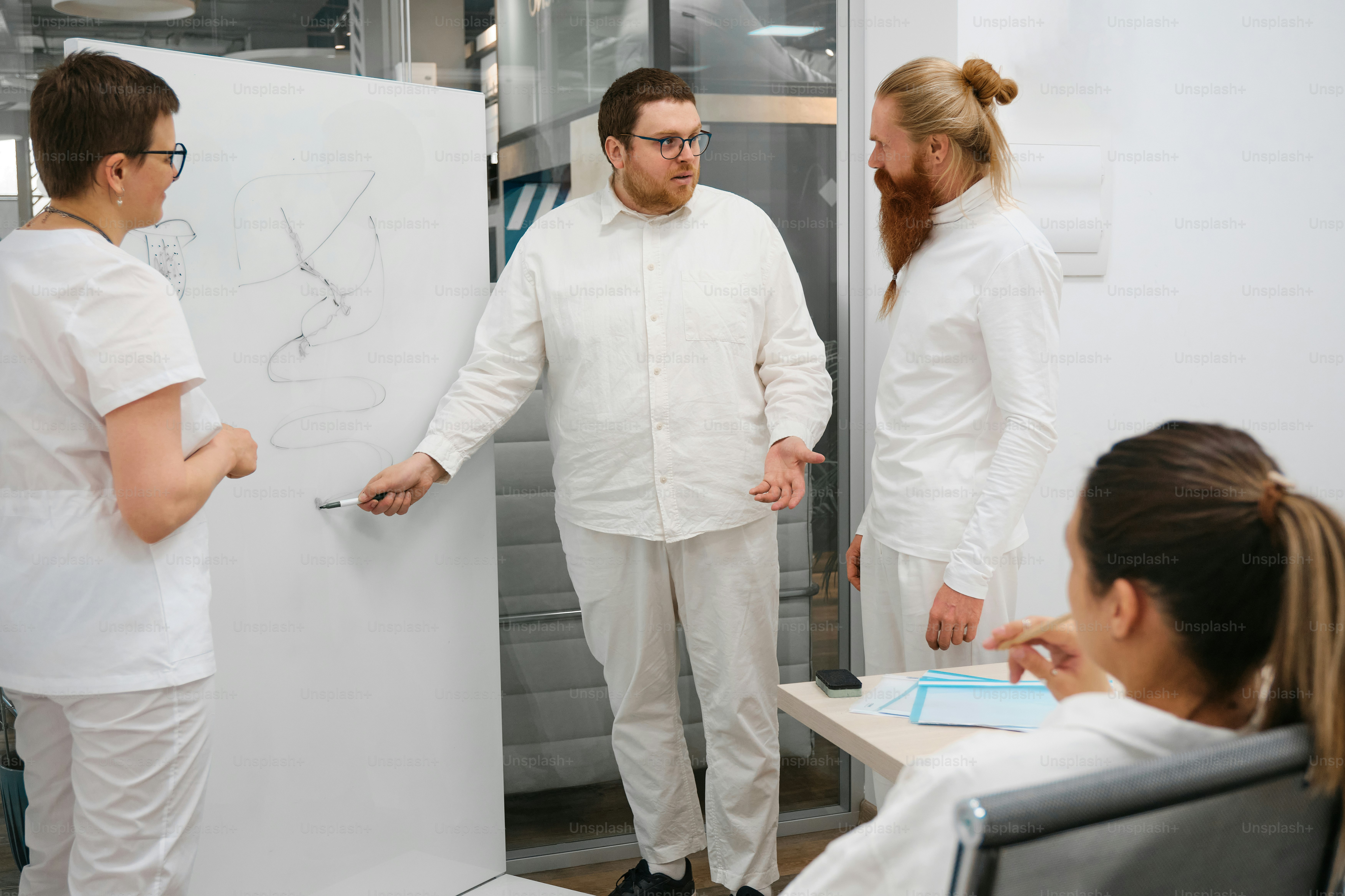 A group of people standing around a white board photo – Education Image ...