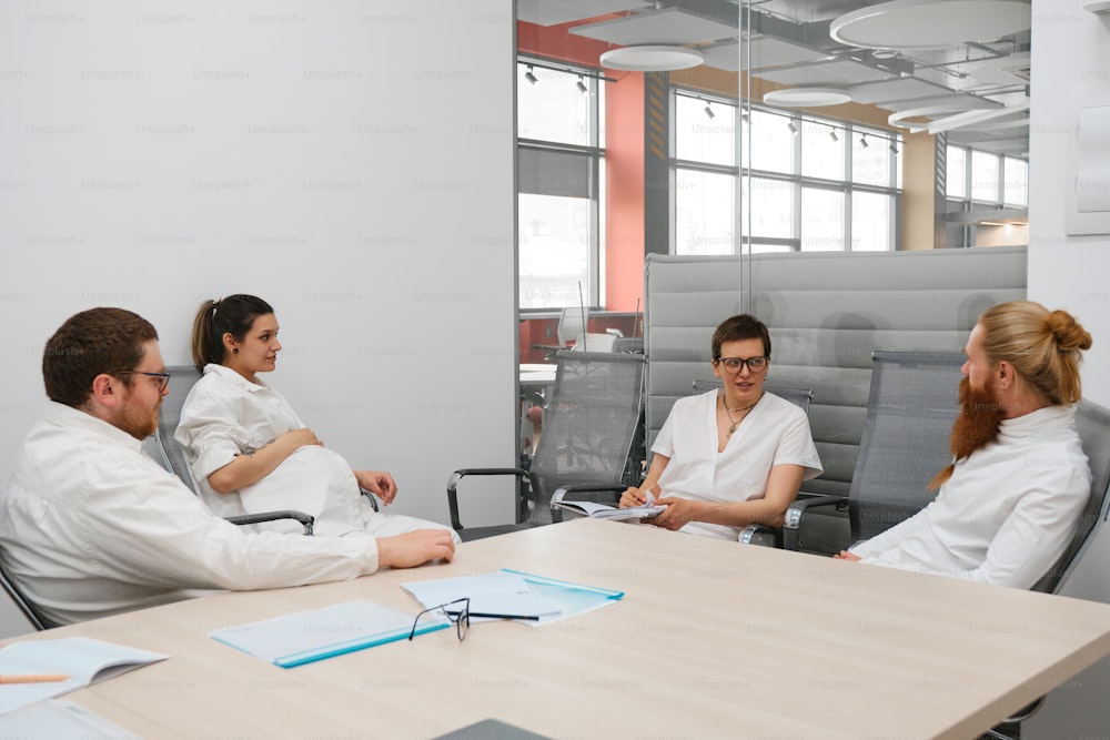 a group of people sitting around a wooden table