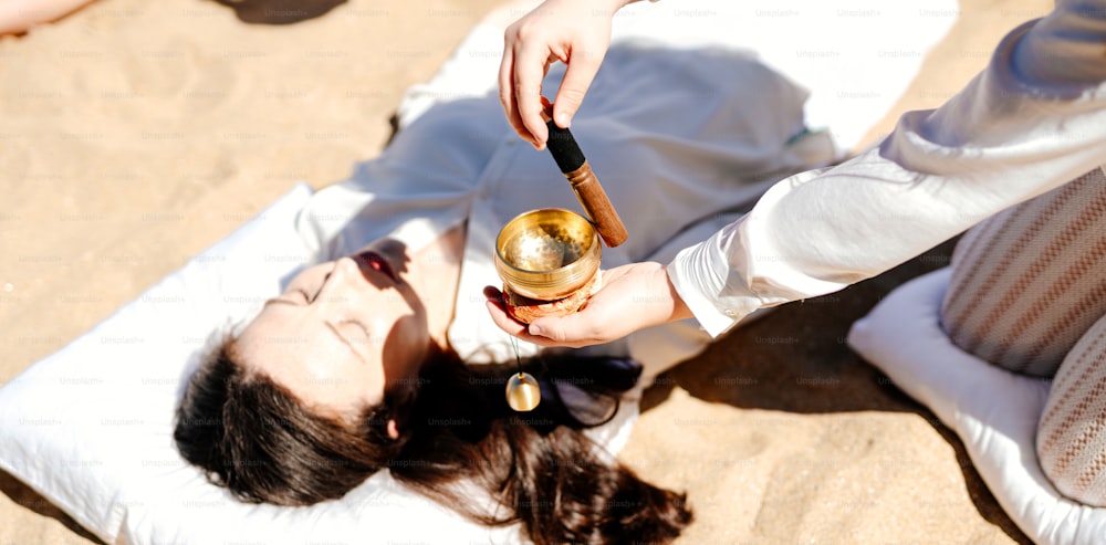 a woman laying on the ground holding a wine glass