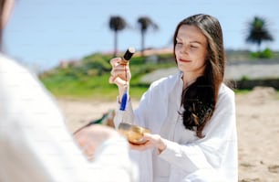 a woman holding a spoon and a bowl of food