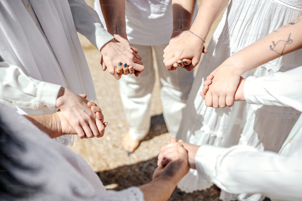 a group of people holding hands in a circle