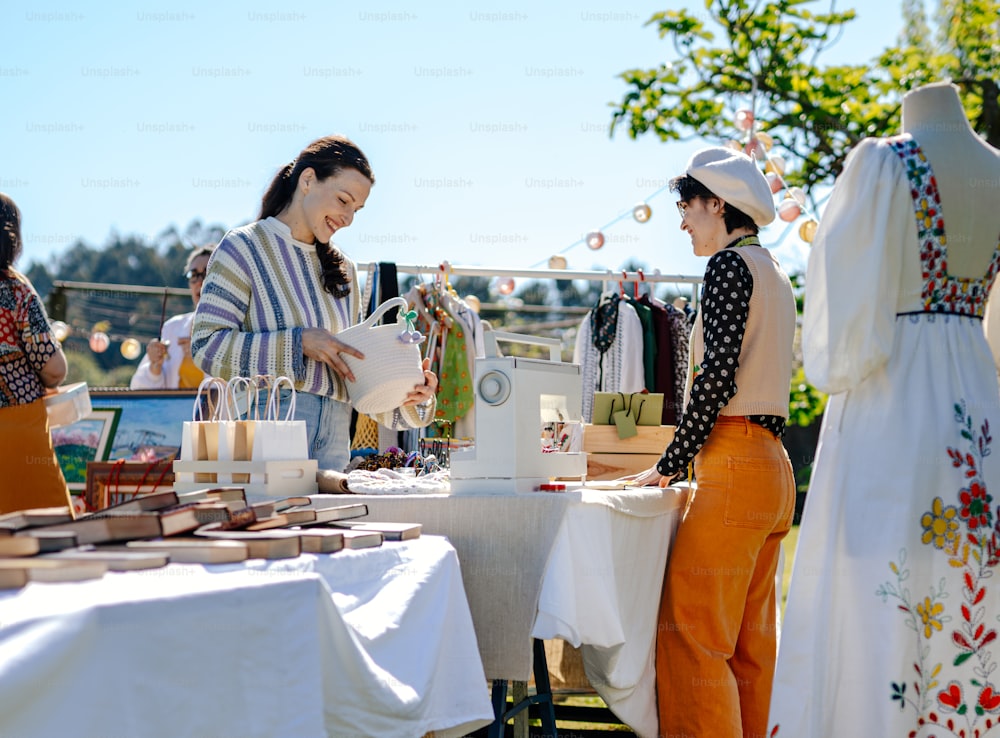 a couple of women standing next to each other at a table