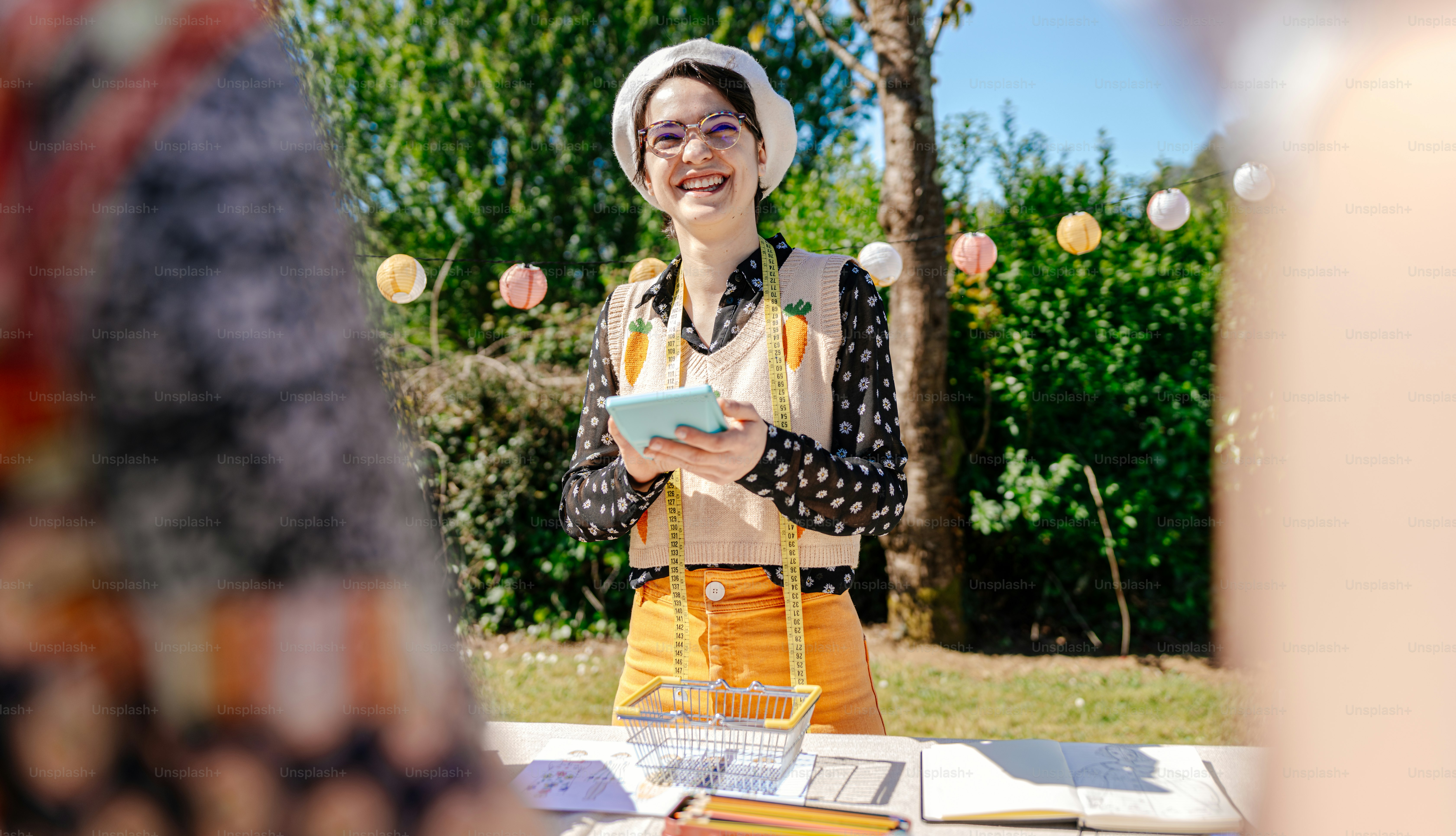 a woman standing in front of a table holding a tablet