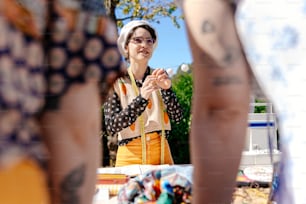 a woman standing in front of a table with food on it