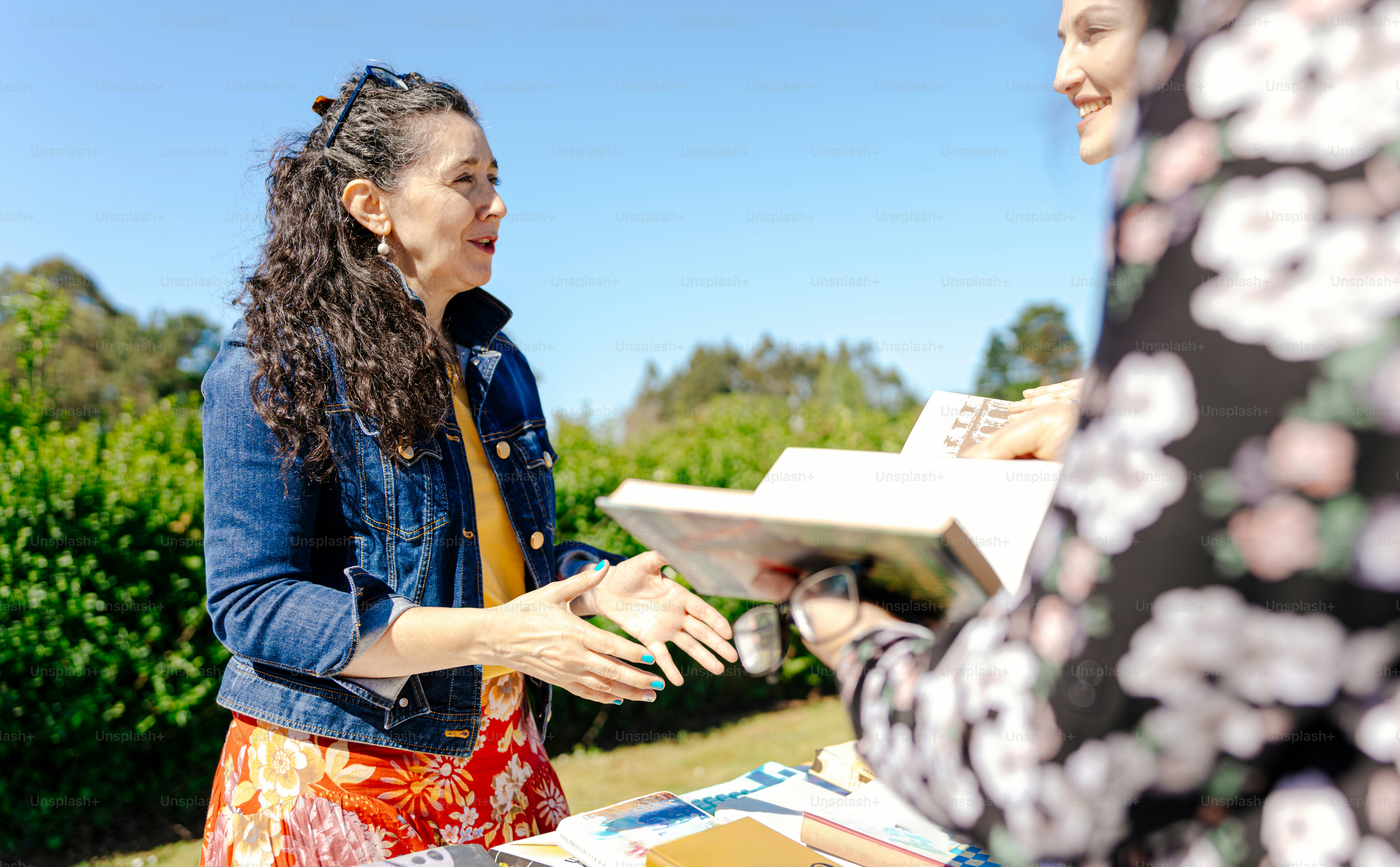 two women standing next to each other at a table