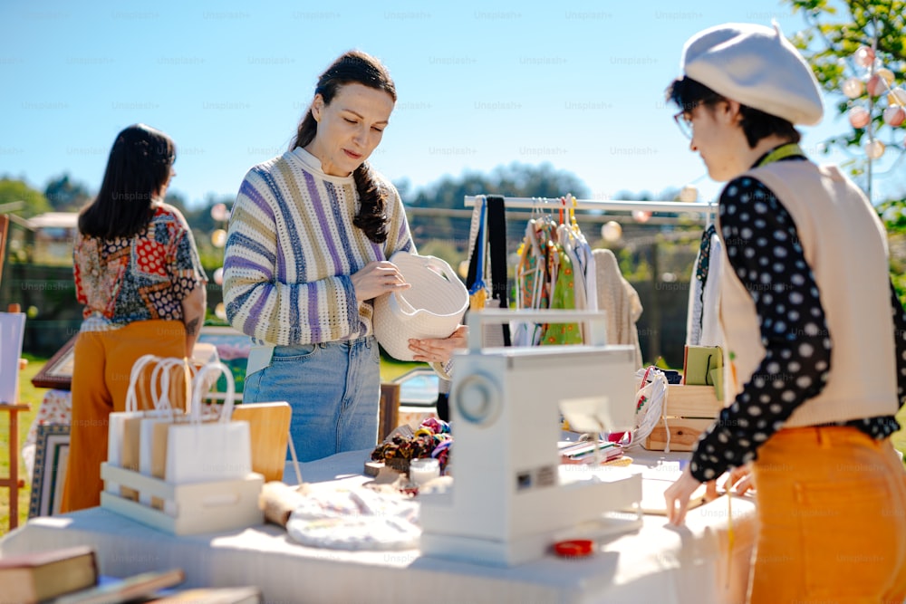 a group of women standing around a table